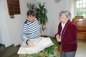 Margie Weiler and Frau Lauk, left, going over the old plan of the town 