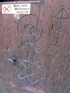 A door with marks from pilgrims, notes to others left behind more than four centuries ago