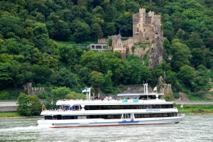 The ship 'Vater Rhein' cruises past a 12th century castle near Assmannshausen